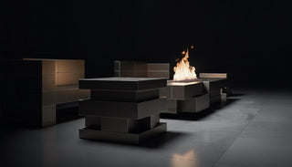 Modern outdoor fire pit table with flames in a dark setting