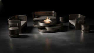 Modern black sofa set with a fire pit in a dark room