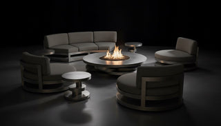 Modern outdoor seating area with a fire pit table in a dark setting